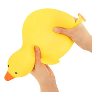 Yellow duck squishy squeeze demonstration; boxed product contains same toy
