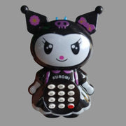 A Kuromi character toy phone held in a hand. The toy features a glossy black and white design with purple accents, including a bow, flowers on the ears, and a skull on the forehead.
