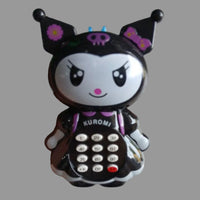 A Kuromi character toy phone held in a hand. The toy features a glossy black and white design with purple accents, including a bow, flowers on the ears, and a skull on the forehead.