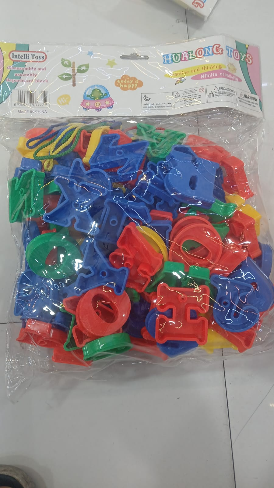 Bag of colourful plastic alphabet letter pieces with lacing cords