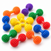 Colourful ribbed connector building pieces shown close up on a white background