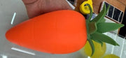 Original supplier photo: Broad orange carrot squishy with a large pointed green leaf crown