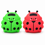 AI-enhanced image: Green and red ladybug squishy toys with black spots and smiling faces; original supplied photo included
