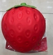 Original supplier photo: Rounded red strawberry squishy with oval seed dimples and a green leaf cap
