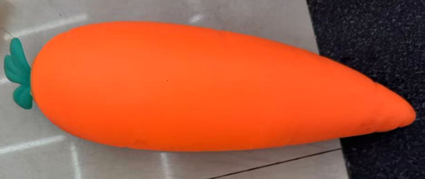 Original supplier photo: Smooth orange carrot squishy with a small green leaf tuft