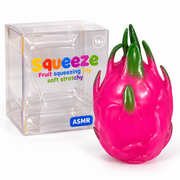 Glossy pink dragon fruit squishy with green leaf details beside its clear retail box